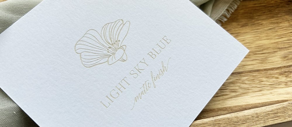 What colorful paper looks like laser engraved - light blue with light brown engraving