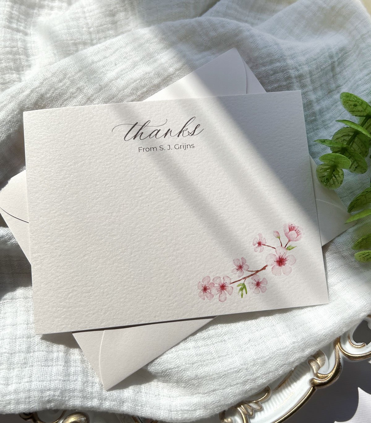 Light pink floral thank you notes printed on shimmery textured blush cardstock